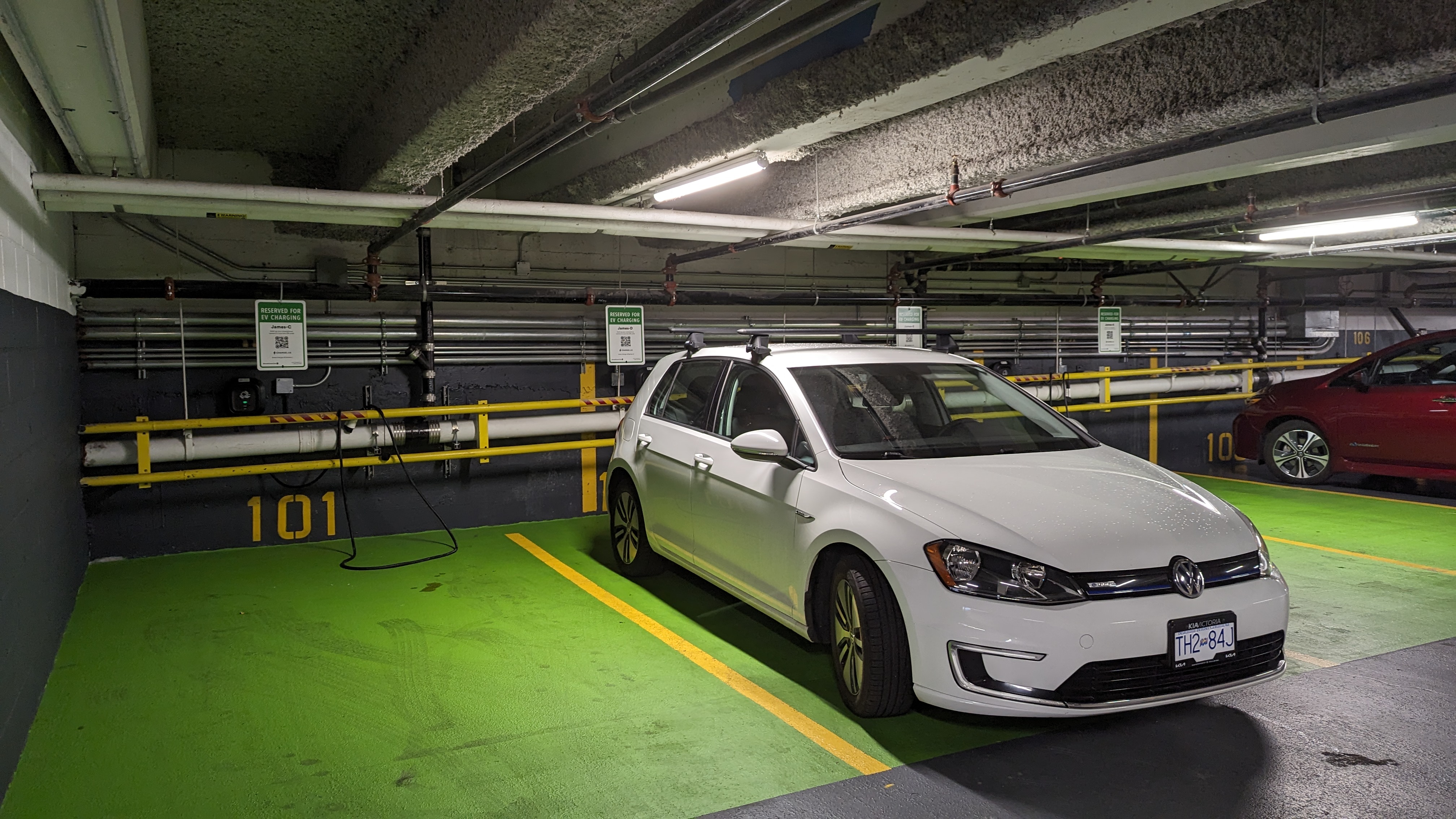 a car charging at an EV charger in an underground parking lot