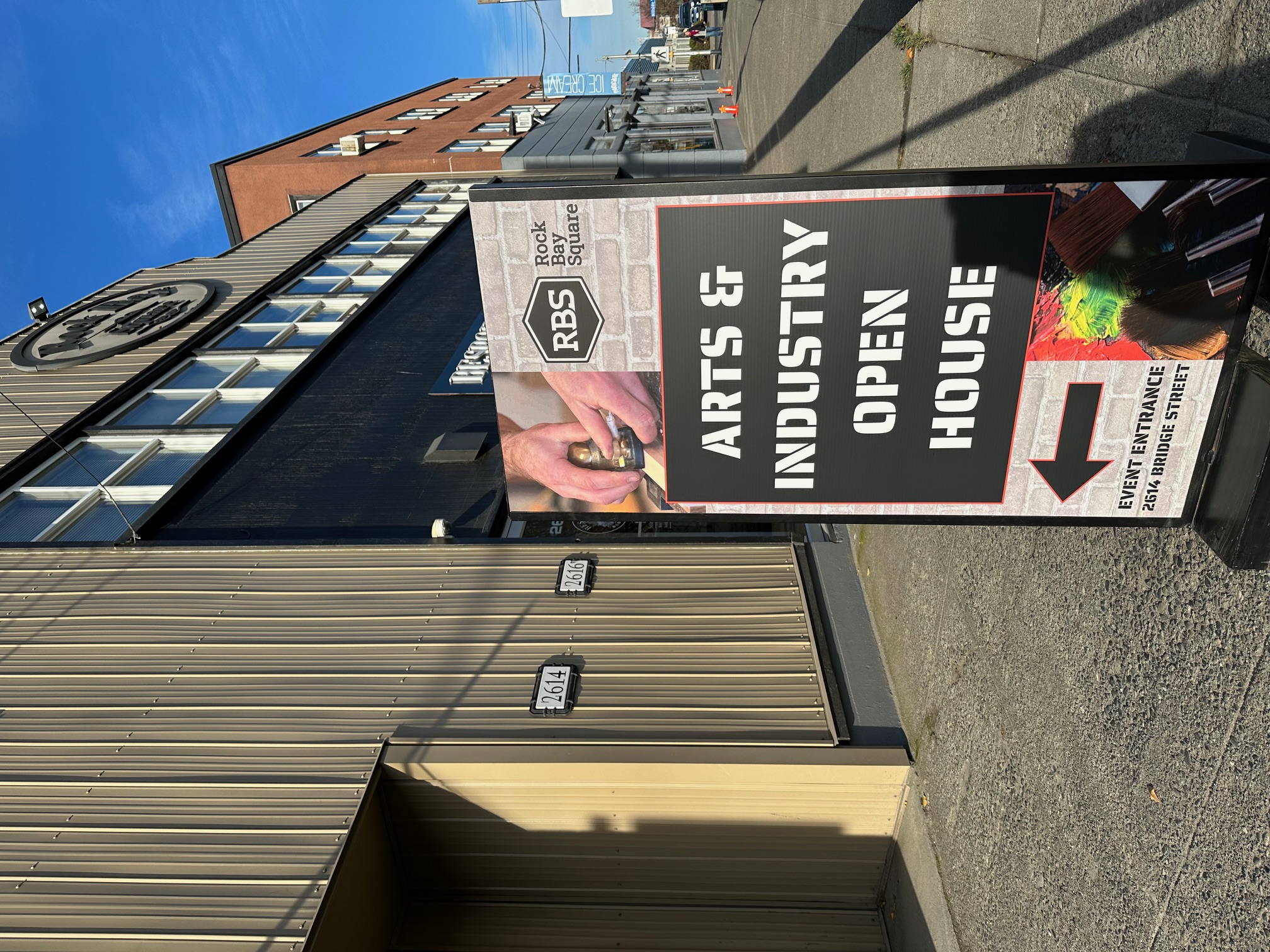 a sign directing patrons into a local art market