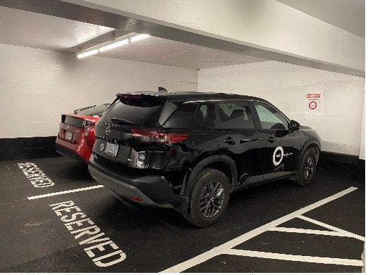 two vehicles using reserved parking spaces