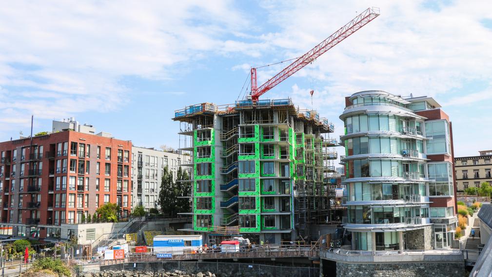 apartment buildings under constructions and a crane