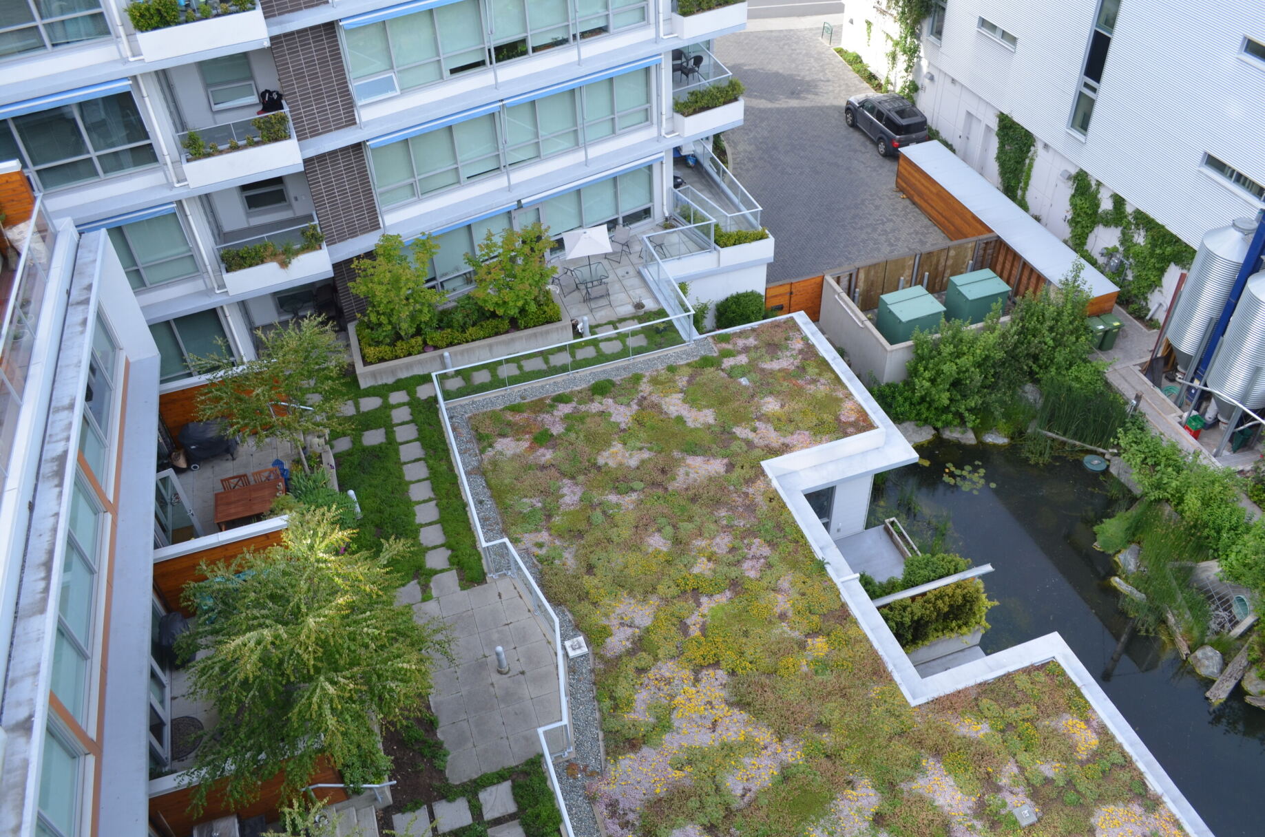 an apartment building with a green-roof and plants