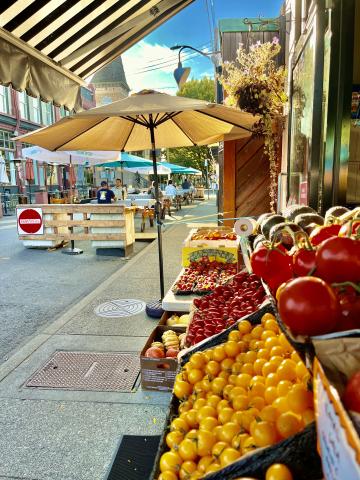 fruitstand outside of a local grocery store in the city