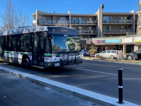 city bus driving in front of a 
